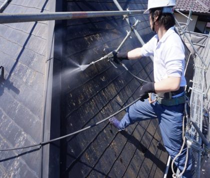 屋根の高圧洗浄中の塗装専門店功栄の職人