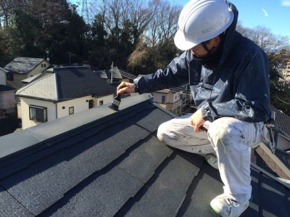 棟板金塗装の為の付帯部の清掃をする功栄の職人